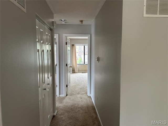 corridor featuring carpet and baseboards