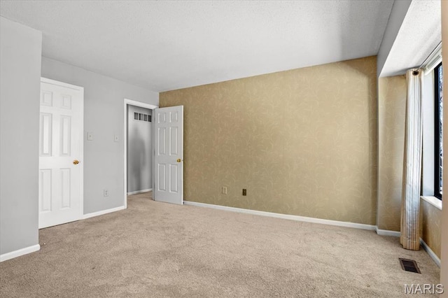 unfurnished bedroom with carpet flooring and baseboards