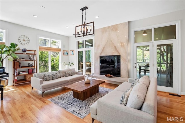 1 W Walinca, Saint Louis, MO 63105 - living area featuring healthy amount of natural light, light wood-style flooring, a chandelier, and recessed lighting