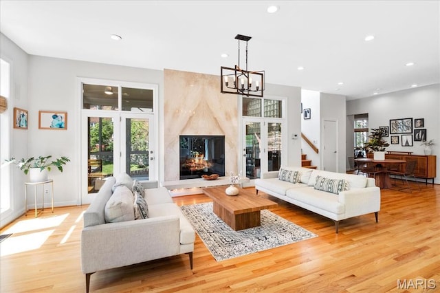 1 W Walinca, Saint Louis, MO 63105 - living room with a chandelier, light wood-style floors, recessed lighting, a high end fireplace, and baseboards