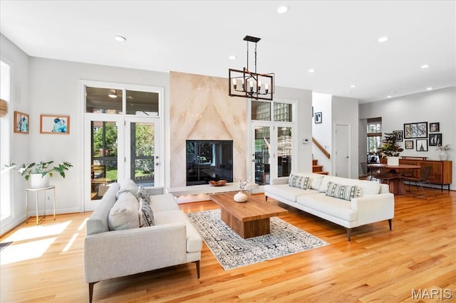 1 W Walinca, Saint Louis, MO 63105 - living area featuring a chandelier, light wood finished floors, recessed lighting, and baseboards