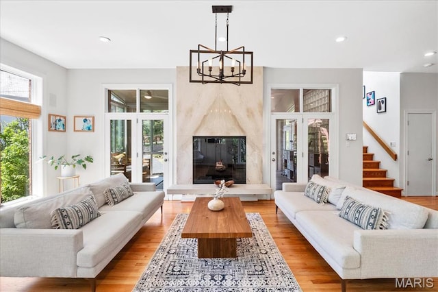 1 W Walinca, Saint Louis, MO 63105 - living area featuring a chandelier, french doors, stairs, light wood finished floors, and recessed lighting