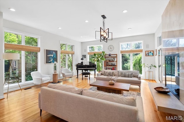 1 W Walinca, Saint Louis, MO 63105 - living area with light wood-type flooring, recessed lighting, and a chandelier