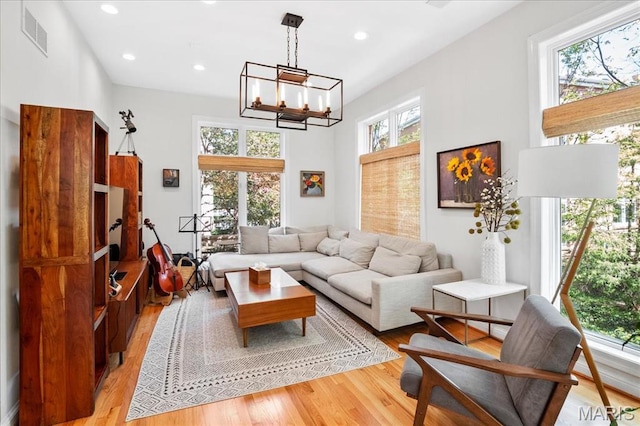 1 W Walinca, Saint Louis, MO 63105 - living area with light wood-style flooring, a chandelier, and recessed lighting