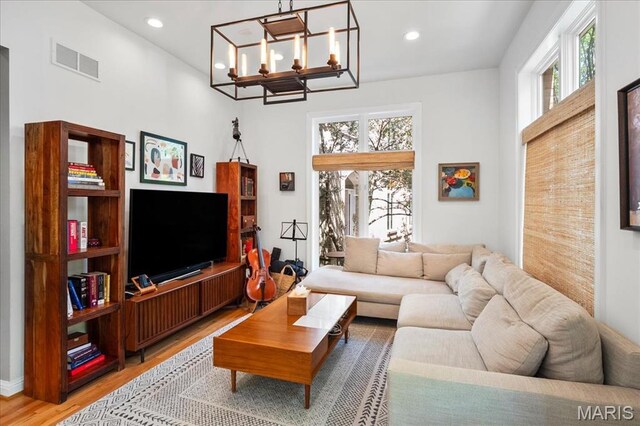 1 W Walinca, Saint Louis, MO 63105 - living area featuring light wood-style floors, a chandelier, and recessed lighting