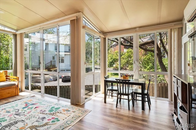 1 W Walinca, Saint Louis, MO 63105 - sunroom with lofted ceiling, a wall mounted air conditioner, expansive windows, and wood finished floors