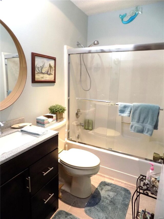 1201 Condo Dr, Rolla, MO 65401 - bathroom with vanity, enclosed tub / shower combo, tile patterned flooring, and toilet