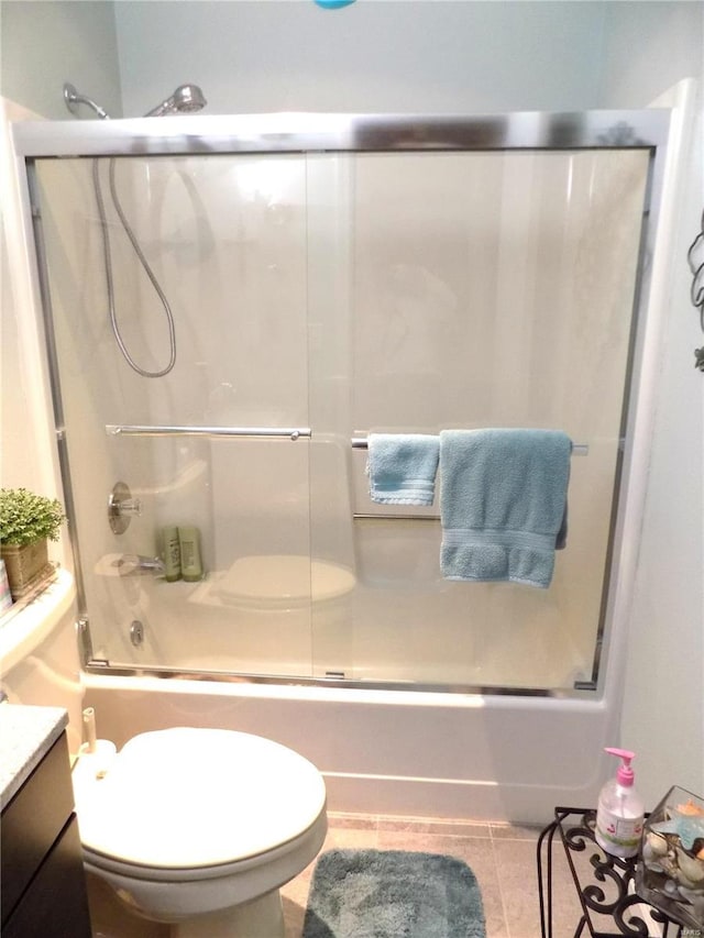 1201 Condo Dr, Rolla, MO 65401 - full bath featuring bath / shower combo with glass door, vanity, tile patterned flooring, and toilet
