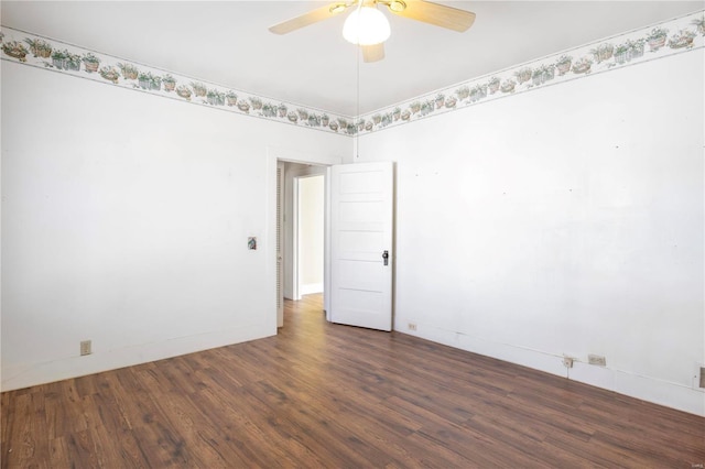 empty room with wood finished floors, a ceiling fan, and baseboards