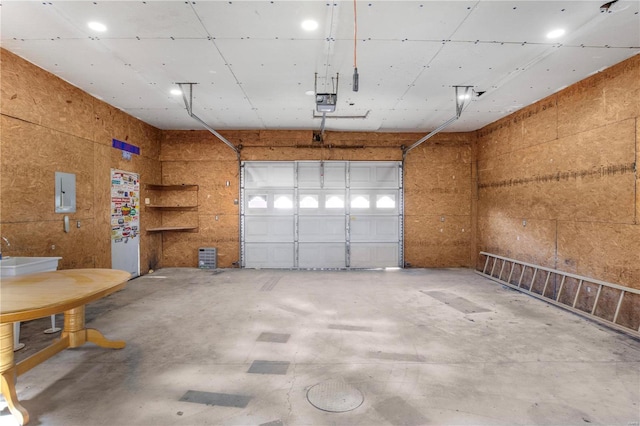 garage featuring electric panel and a garage door opener