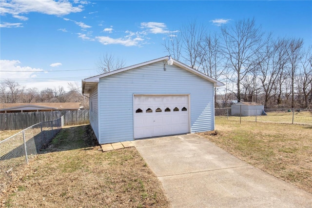 detached garage featuring concrete driveway