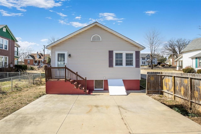 rear view of house with a patio, a fenced backyard, and a residential view