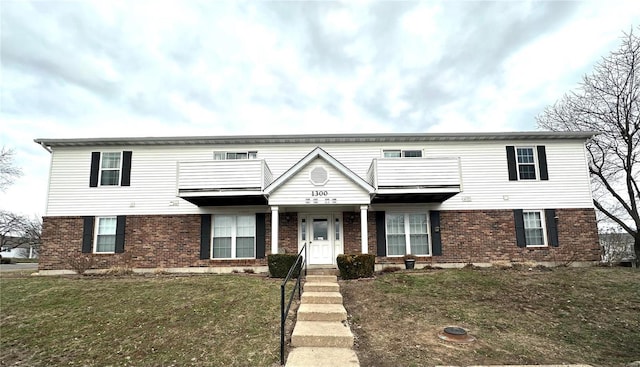 1308 Condo Dr, Rolla, MO 65401 - view of front of home featuring a balcony, brick siding, and a front lawn