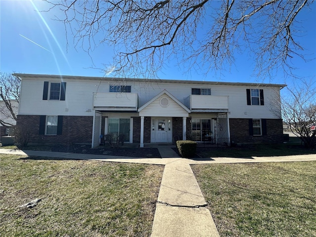 1308 Condo Dr, Rolla, MO 65401 - view of front facade with brick siding, a front yard, and a porch