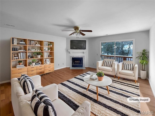 813 Sugar Valley Ct Unit 8, Saint Peters, MO 63376 - living room featuring a ceiling fan, a high end fireplace, wood finished floors, and baseboards