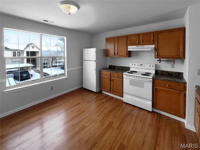 813 Sugar Valley Ct Unit 8, Saint Peters, MO 63376 - kitchen featuring white appliances, under cabinet range hood, brown cabinets, and dark countertops