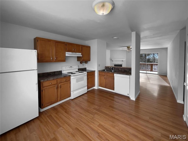 813 Sugar Valley Ct Unit 8, Saint Peters, MO 63376 - kitchen with white appliances, dark countertops, under cabinet range hood, and brown cabinetry