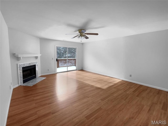 813 Sugar Valley Ct Unit 8, Saint Peters, MO 63376 - unfurnished living room with ceiling fan, a high end fireplace, wood finished floors, and baseboards
