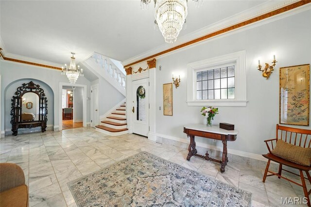4386 Westminster Pl, Saint Louis, MO 63108 - entryway with a chandelier, stairway, crown molding, and marble look tile flooring