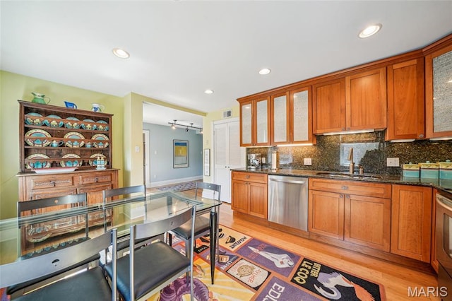 4386 Westminster Pl, Saint Louis, MO 63108 - kitchen featuring dishwasher, backsplash, light wood-style floors, glass insert cabinets, and recessed lighting
