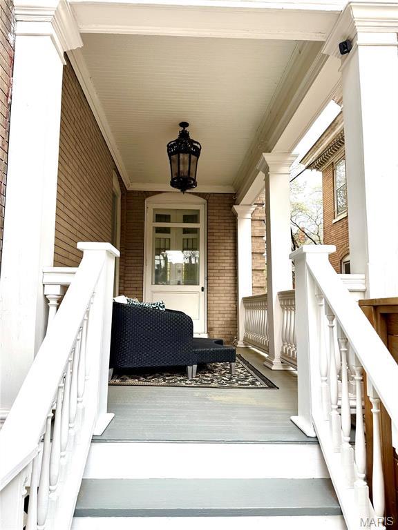 4386 Westminster Pl, Saint Louis, MO 63108 - view of exterior entry featuring a porch and brick siding