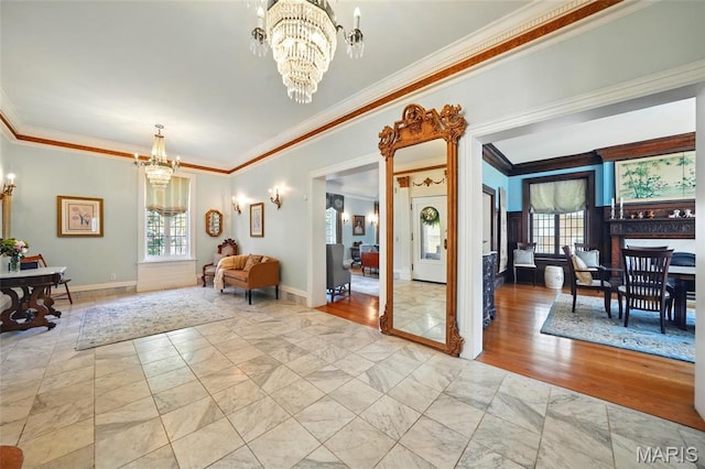 4386 Westminster Pl, Saint Louis, MO 63108 - entryway with ornamental molding, a chandelier, healthy amount of natural light, and light marble finish flooring