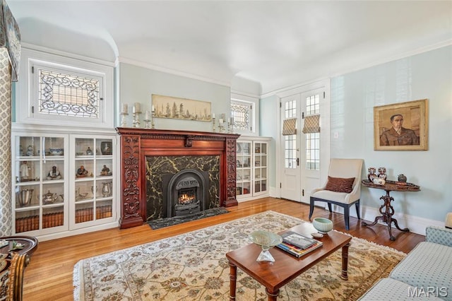 4386 Westminster Pl, Saint Louis, MO 63108 - living room with wood finished floors, a high end fireplace, and ornamental molding