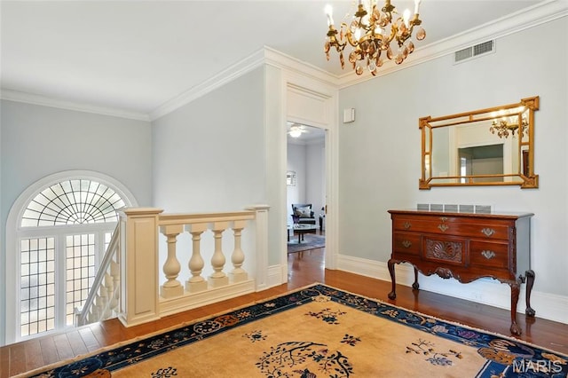4386 Westminster Pl, Saint Louis, MO 63108 - hallway with a chandelier, wood finished floors, and crown molding
