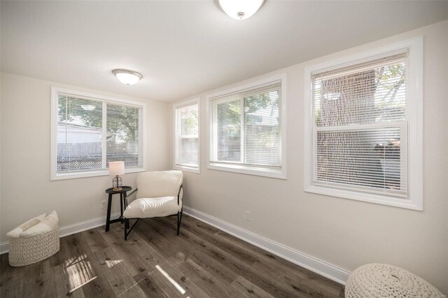 6758 Kenwood Dr, Saint Louis, MO 63121 - living area with dark wood finished floors, baseboards, and healthy amount of natural light