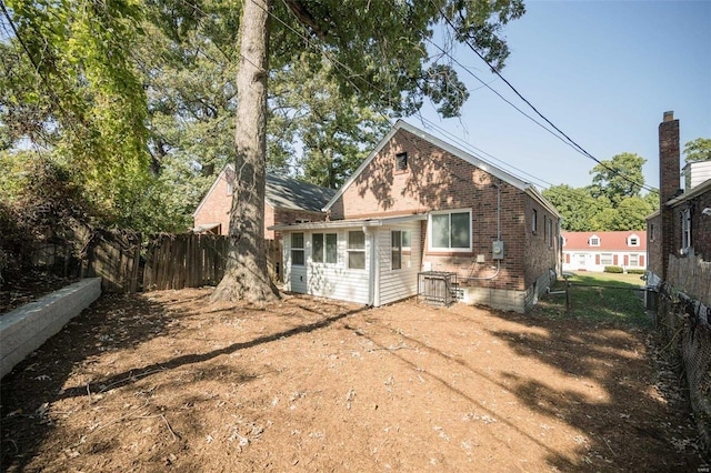 6758 Kenwood Dr, Saint Louis, MO 63121 - rear view of house featuring brick siding and a fenced backyard