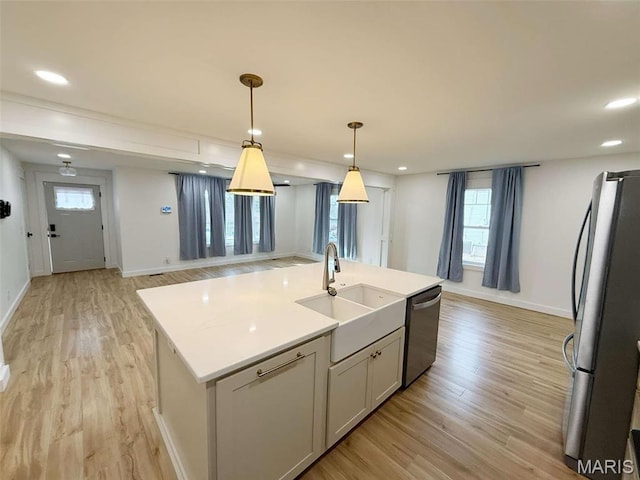 1400 S Jackson St, Salem, MO 65560 - kitchen with appliances with stainless steel finishes, a sink, light wood-style flooring, light countertops, and baseboards