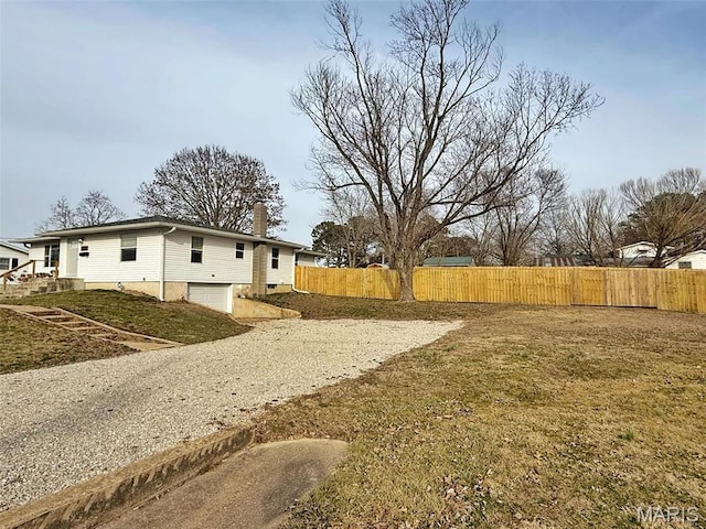 1400 S Jackson St, Salem, MO 65560 - view of yard featuring an attached garage, gravel driveway, and fence