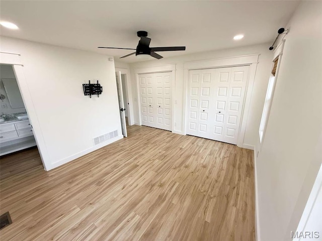 1400 S Jackson St, Salem, MO 65560 - unfurnished bedroom with light wood-style flooring, recessed lighting, multiple closets, baseboards, and a ceiling fan