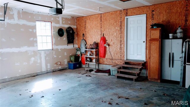 2630 Melody Ln, Cuba, MO 65453 - garage with a garage door opener and freestanding refrigerator