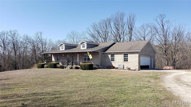 2630 Melody Ln, Cuba, MO 65453 - view of front of house featuring covered porch, an attached garage, brick siding, driveway, and a front lawn