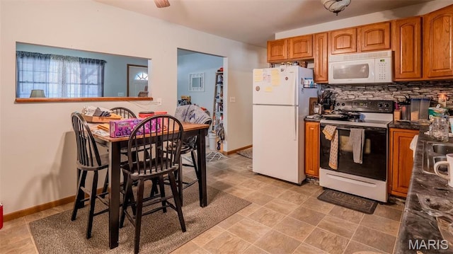 409 County Road 32b, Ironton, MO 63650 - kitchen with white appliances, brown cabinets, backsplash, and dark countertops
