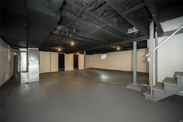 3433 Pine Grove Ave, Saint Louis, MO 63121 - basement featuring stairs, heating unit, and water heater