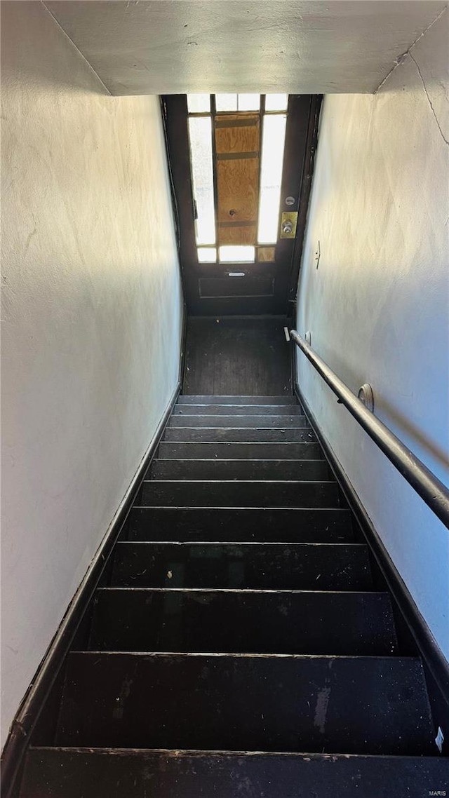 staircase featuring hardwood / wood-style floors