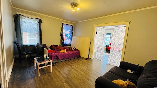 bedroom featuring wood finished floors and crown molding