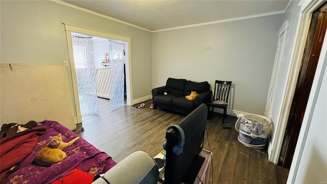 bedroom with wood finished floors, ornamental molding, access to exterior, and baseboards