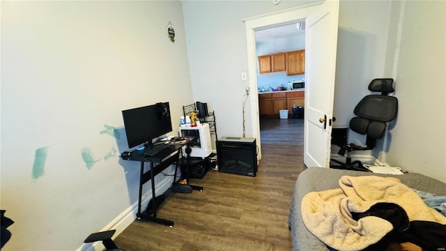home office featuring dark wood-type flooring and baseboards