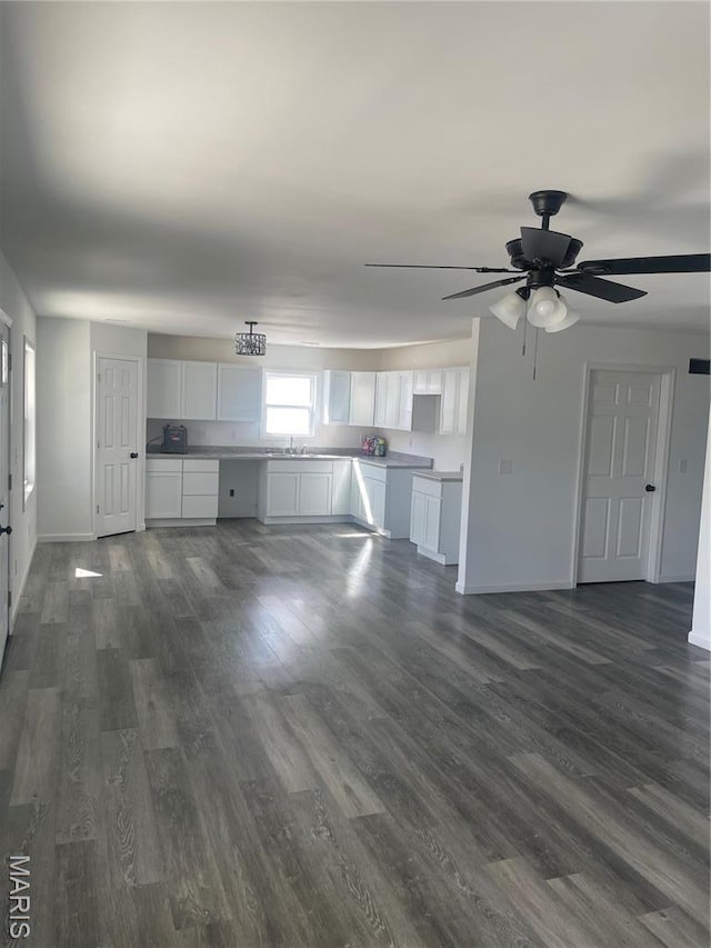 806 E Dover St, Monroe City, MO 63456 - unfurnished living room with dark wood finished floors, a sink, baseboards, and a ceiling fan