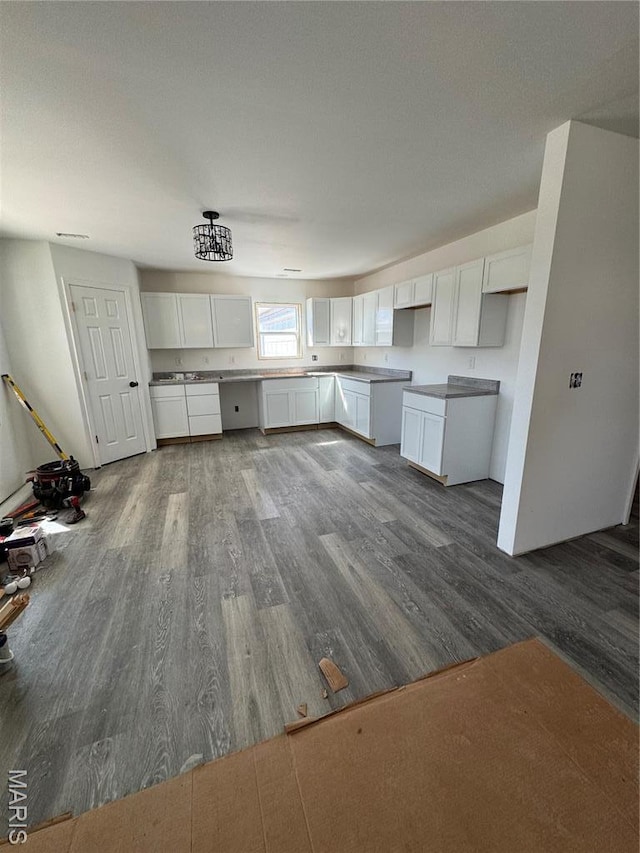806 E Dover St, Monroe City, MO 63456 - kitchen with dark wood finished floors and white cabinetry