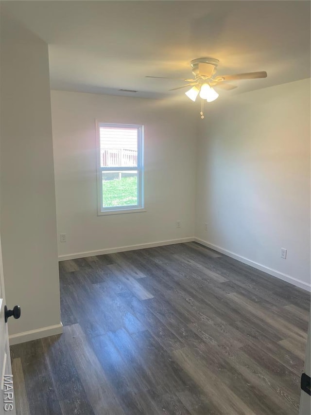 806 E Dover St, Monroe City, MO 63456 - empty room featuring baseboards, dark wood-type flooring, and ceiling fan