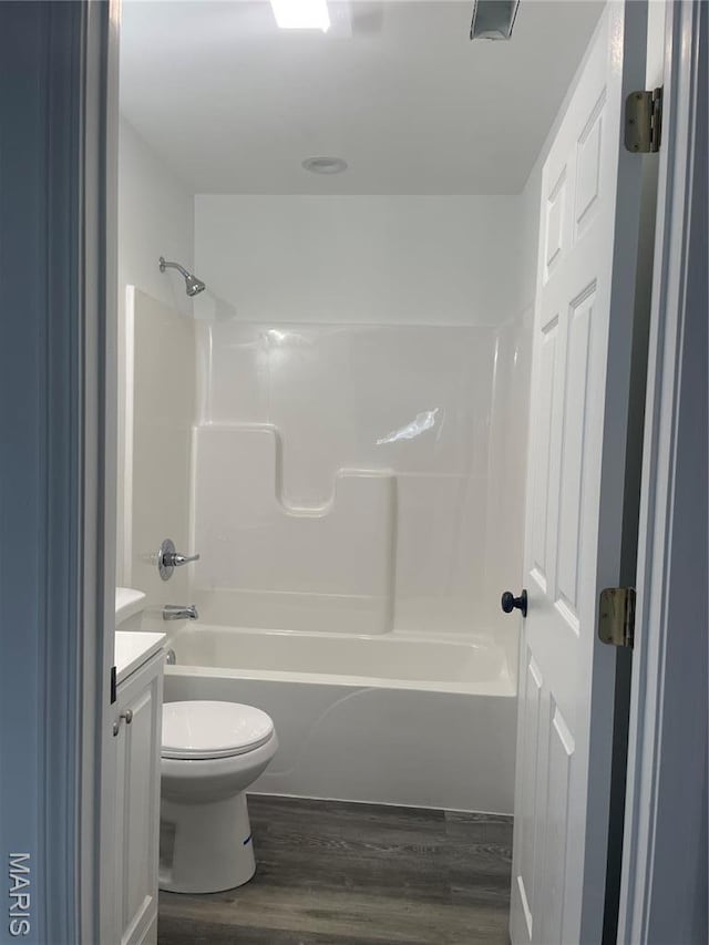 806 E Dover St, Monroe City, MO 63456 - full bath with wood finished floors, vanity, toilet, and bathing tub / shower combination