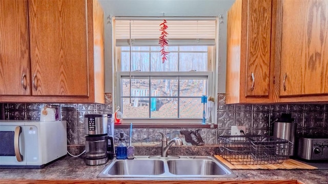 528 N Shepherd St, Ironton, MO 63650 - kitchen featuring white microwave, a sink, brown cabinets, and tasteful backsplash