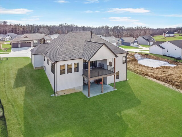 101 Stone Canyon Blvd, Foristell, MO 63348 - rear view of property with a residential view, a patio area, a lawn, and roof with shingles