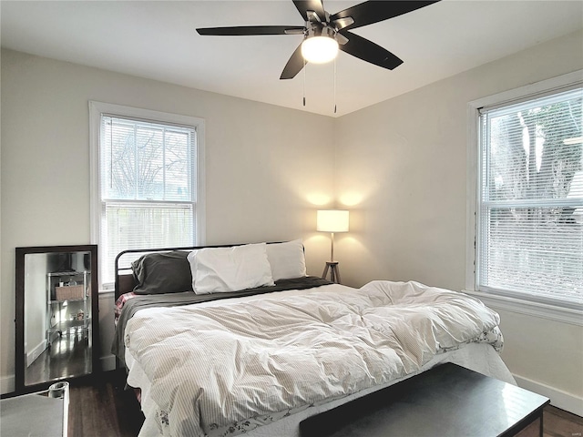 305 Williams St, Washington, MO 63090 - bedroom featuring baseboards, multiple windows, wood finished floors, and ceiling fan