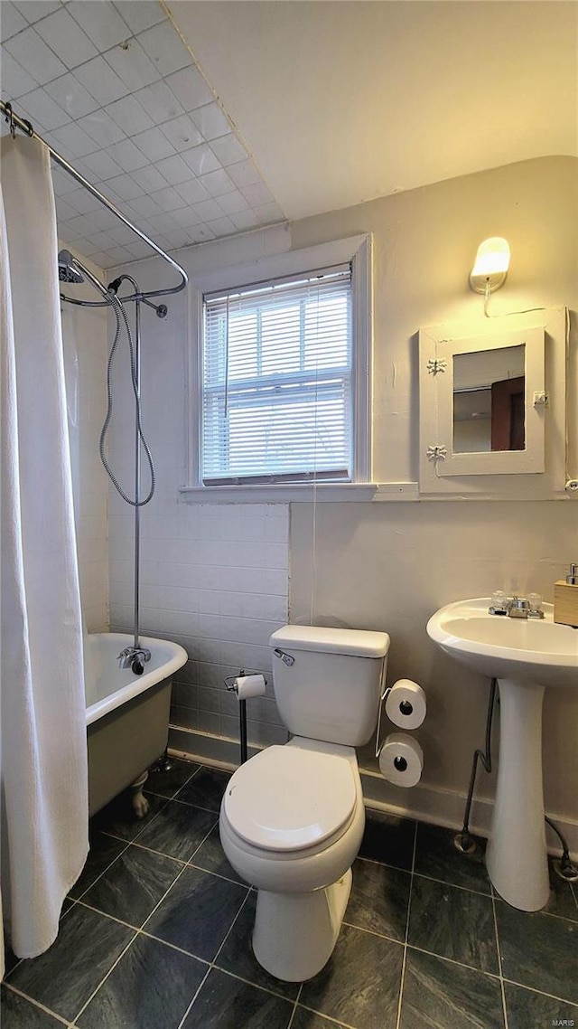 305 Williams St, Washington, MO 63090 - full bathroom with toilet, tile patterned flooring, shower / bath combo with shower curtain, tile walls, and a sink