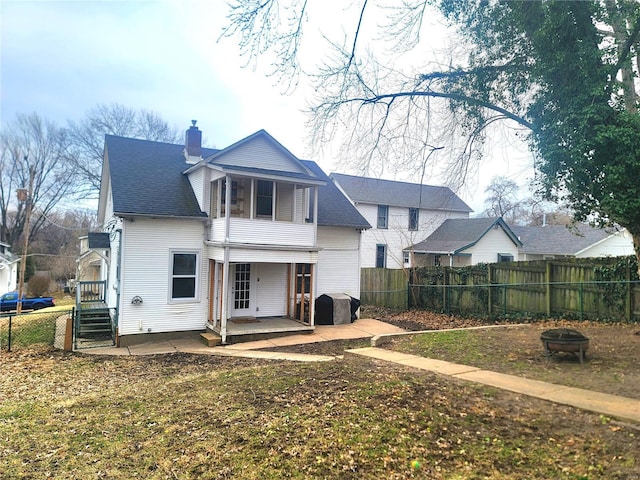 305 Williams St, Washington, MO 63090 - rear view of property featuring a fire pit, a fenced backyard, a chimney, and a patio